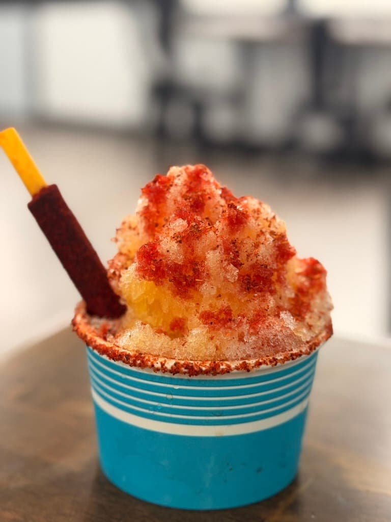 The 410 Diablo mango snowball dusted with Tajín, rimmed with chamoy, with a tamarind straw