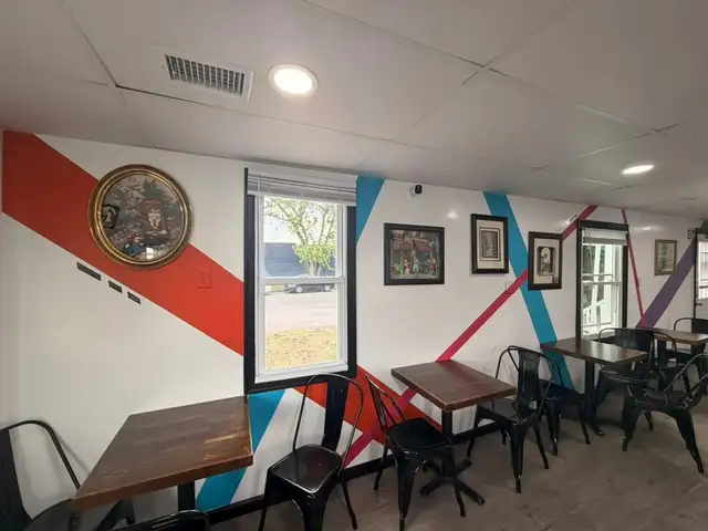 The colorful art wall above the seating tables inside Just Chillin